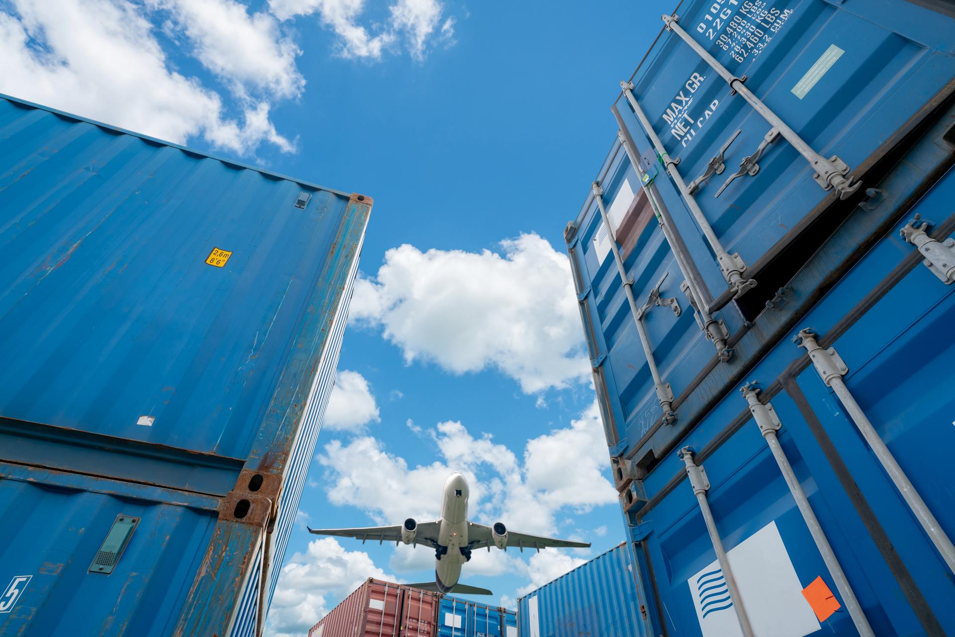 airplane-flying-above-logistic-container-air-